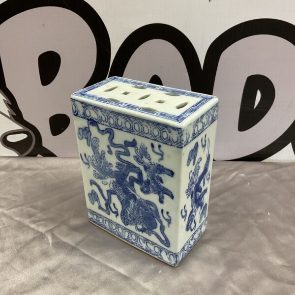 Vintage Chinese blue and white porcelain opium pillow with dragon decoration and pierced top
