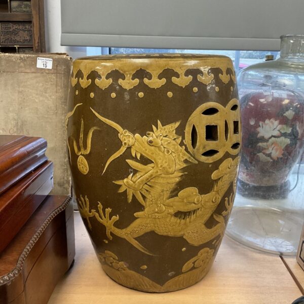 Vintage Chinese glazed pottery garden stool with raised yellow dragon design on brown glaze