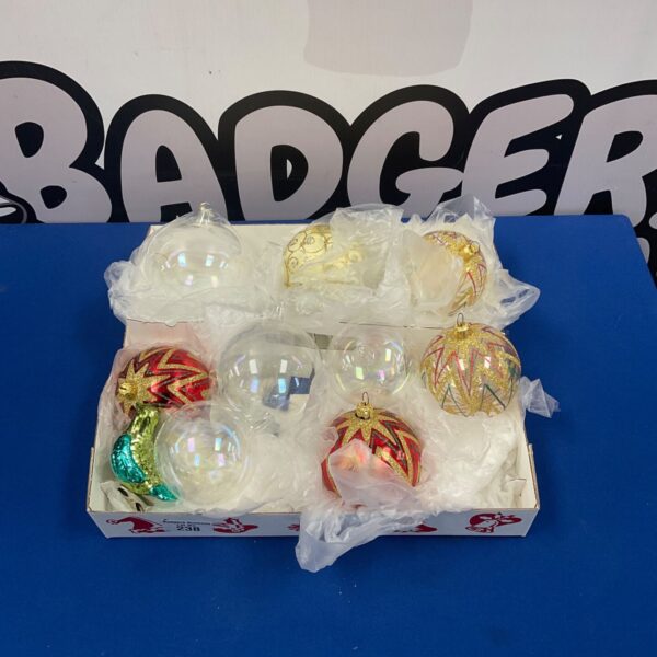 Box of colourful vintage glass Christmas baubles for festive decor.