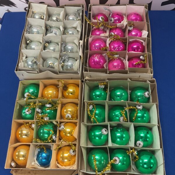 Four boxes of vintage glass Christmas tree decorations in various colours.