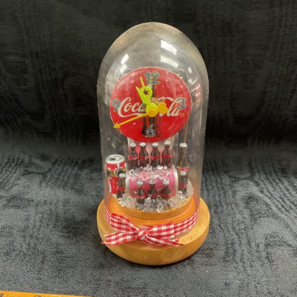 Vintage Coca-Cola dome case clock with miniature bottles and red roundel face