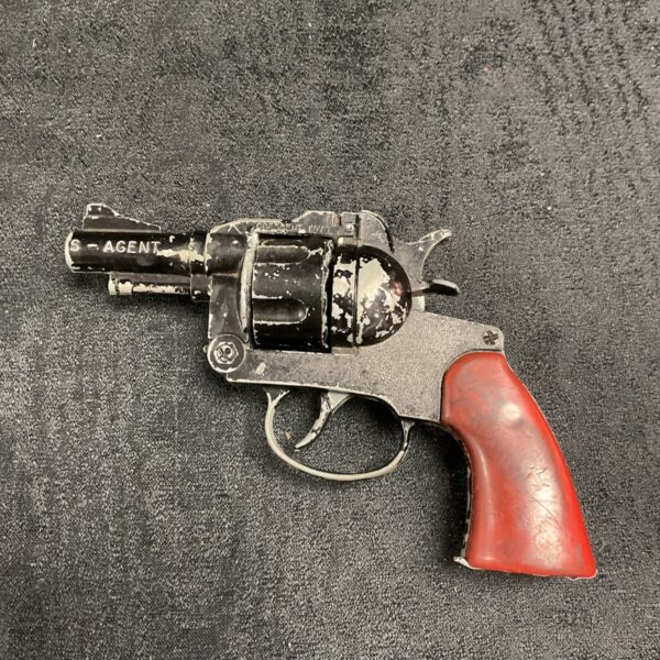 Vintage Crescent Toys agent cap gun with black metal finish and red grip
