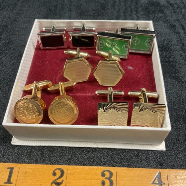 Vintage cufflinks lot with gold tone finishes and varied designs.