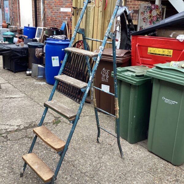 Vintage decorators step ladder in a garden setting.