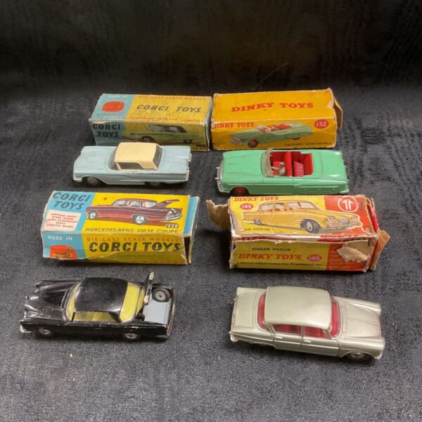 Vintage Dinky and Corgi diecast model cars with original boxes, including Singer Vogue and Packard Convertible