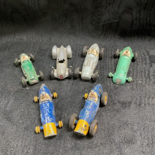 Six vintage Dinky die-cast racing cars including a silver Auto Union
