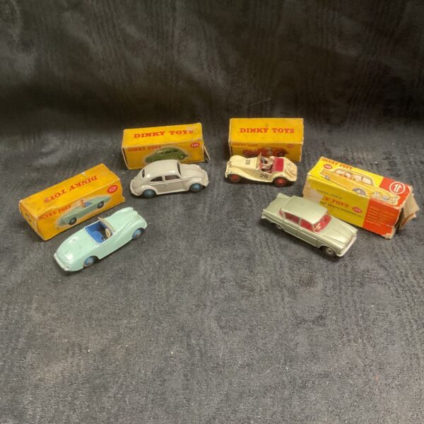 Four vintage Dinky Toys cars including Singer Vogue with original boxes