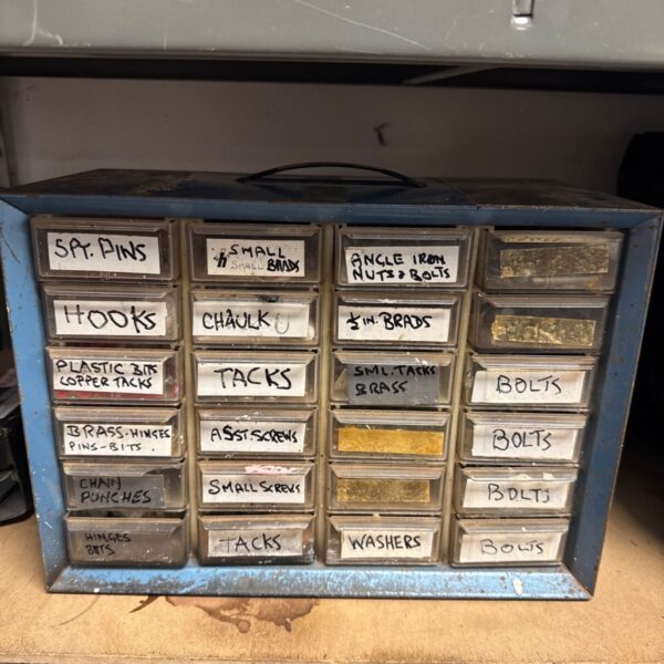 Vintage metal engineers cabinet filled with small parts and fixings.