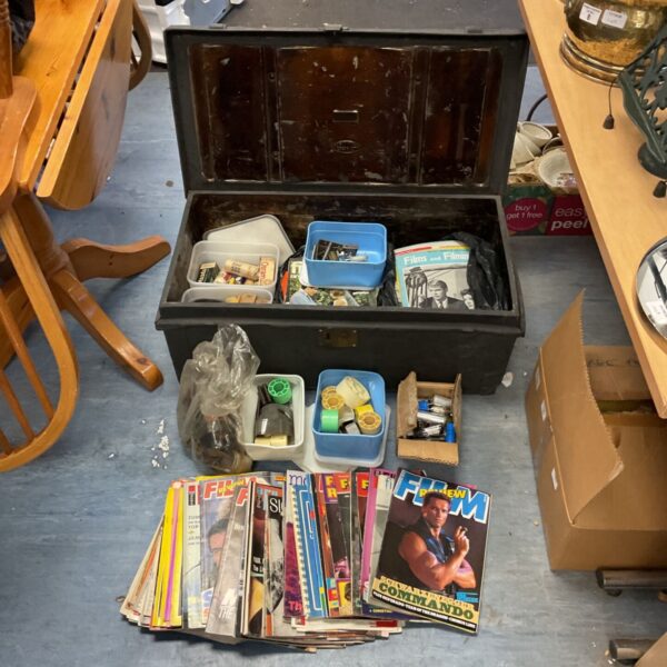 Vintage film and projection equipment lot in a wooden chest.