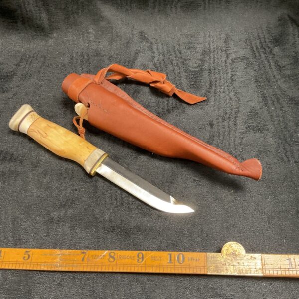 Vintage Scandinavian fishing knife with leather sheath, showing blade and handle.