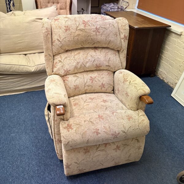 Vintage floral riser recliner chair with cream upholstery and wooden arm caps