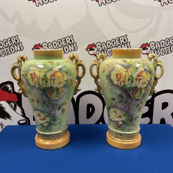 Pair of vintage hand-painted floral vases with detailed designs.