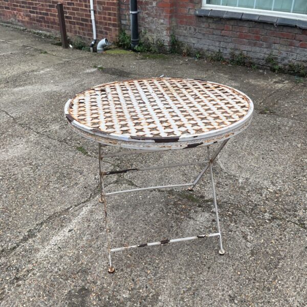 Vintage metal foldable garden table with pierced design.