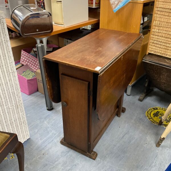Vintage wooden folding gate leg table with turned legs.