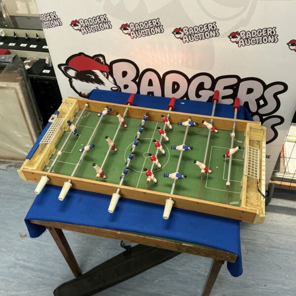 Vintage Fussball tabletop game with wooden cabinet and players.