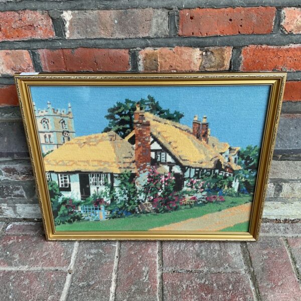 Vintage gilt framed embroidery of a thatched cottage and church in a flower garden