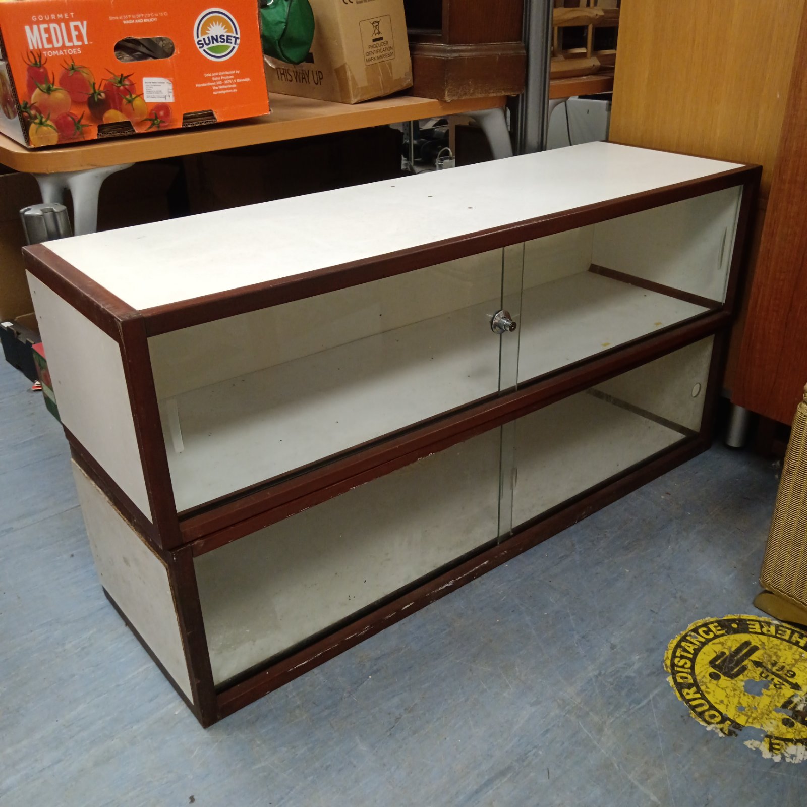 Vintage glass fronted display cabinet with wooden frame.