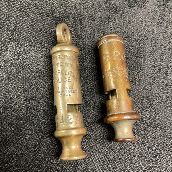 Two vintage Hudson whistles, one Metropolitan Police and one GPO