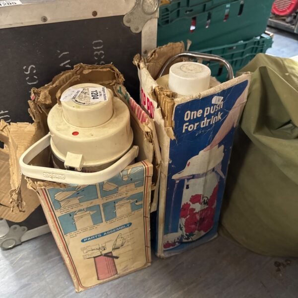 Vintage insulated flasks with pressure valve and original packaging.