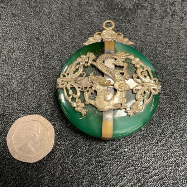 Vintage jade pendant with dragon motif and silver filigree.