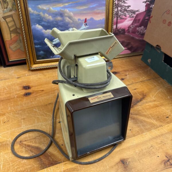 Vintage Kodaslide table projector with chute for slides.
