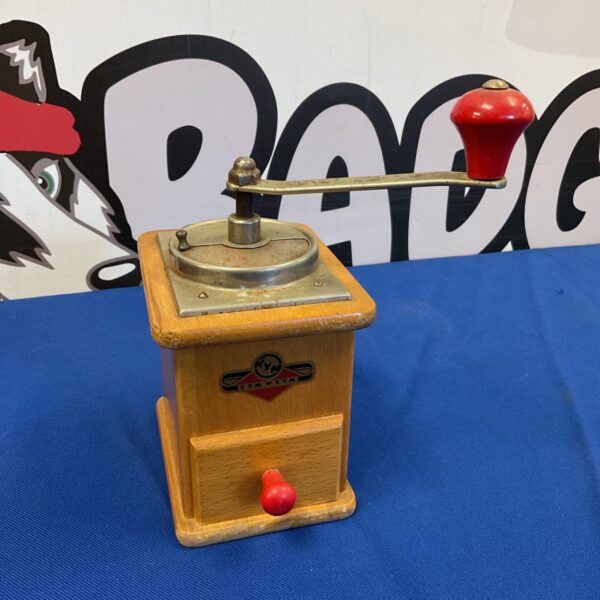 Vintage Kym Kym coffee grinder with wooden body and metal parts.