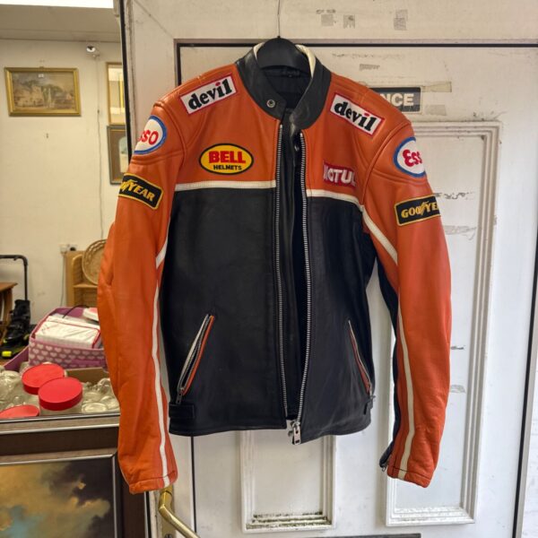 Front view of a vintage orange and black leather motorcycle jacket.