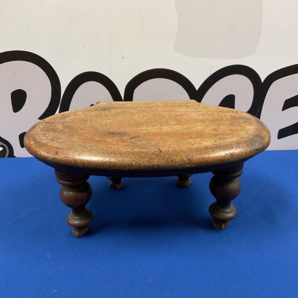 Vintage low country footstool with turned legs and oval top.
