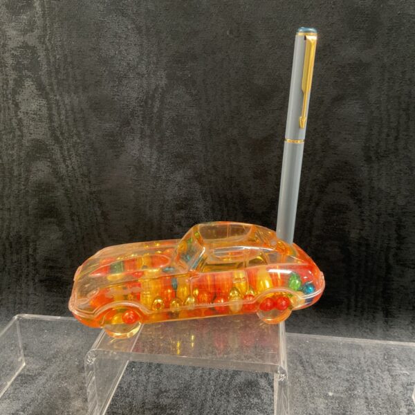 Vintage lucite E Type Jaguar pen stand with colourful beads.