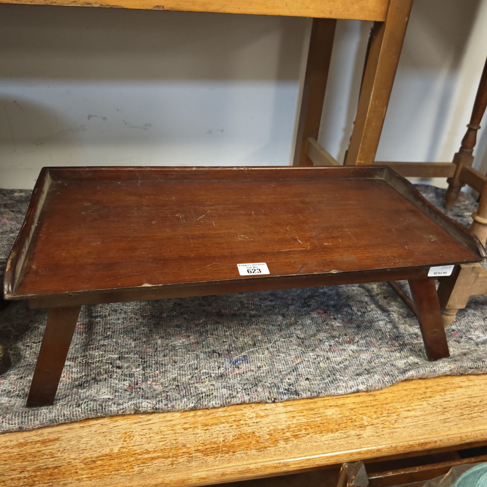 Vintage mahogany breakfast bed tray with folding legs.