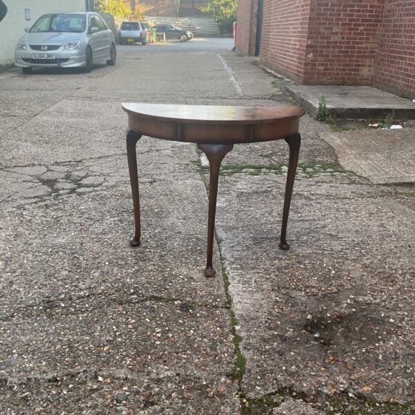 Vintage mahogany demi-lune card table with cabriole legs.