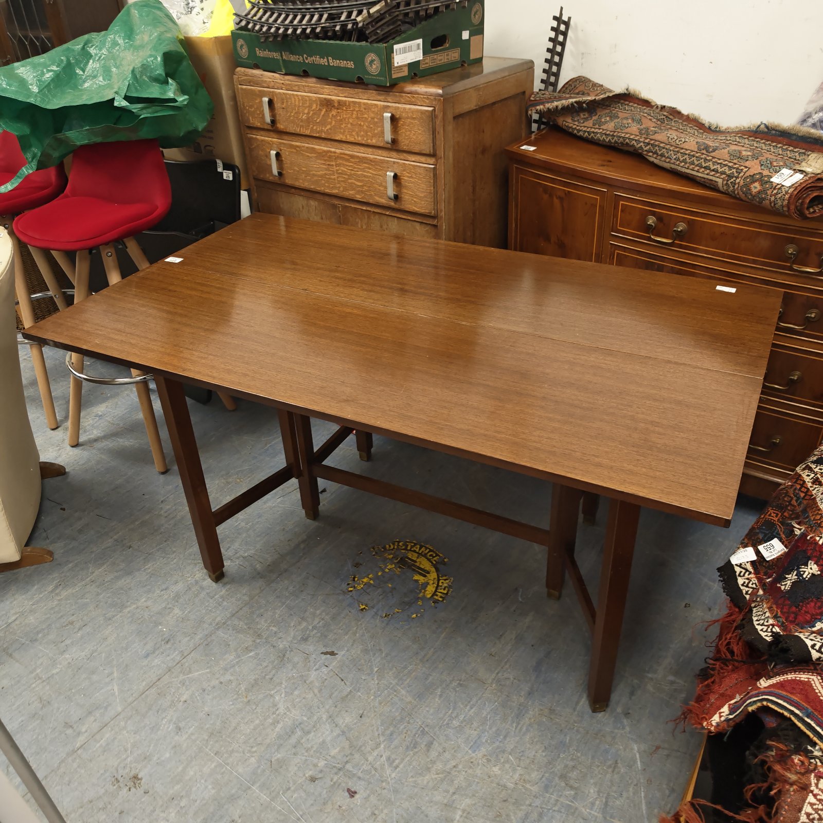 Vintage mahogany drop leaf dining table with stretcher-supported legs