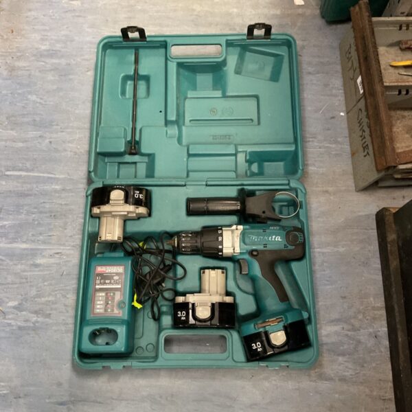 Vintage Makita cordless drill kit in open case.