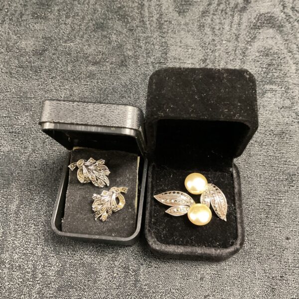 Vintage marcasite stud earrings displayed in a box.