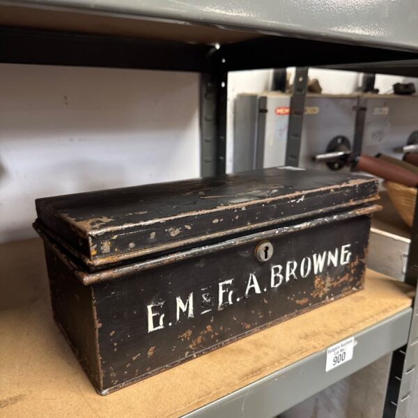 Vintage metal box with "E.M. Browne" painted on the lid.