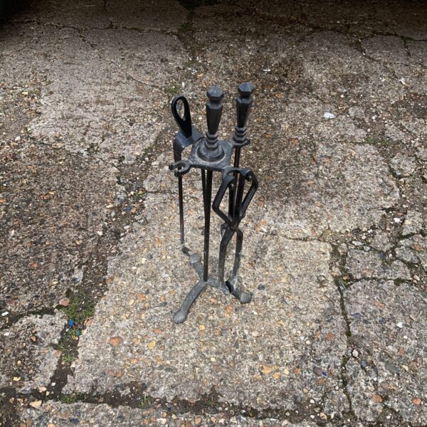 Vintage metal fire side set with shovel, poker, and tongs.