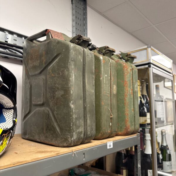 Vintage metal jerry can with faded paint and handle.