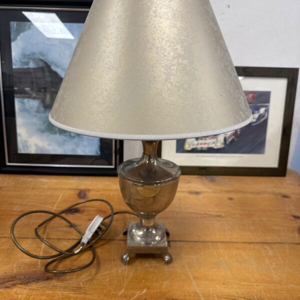 Vintage silver metal table lamp with beige shade.