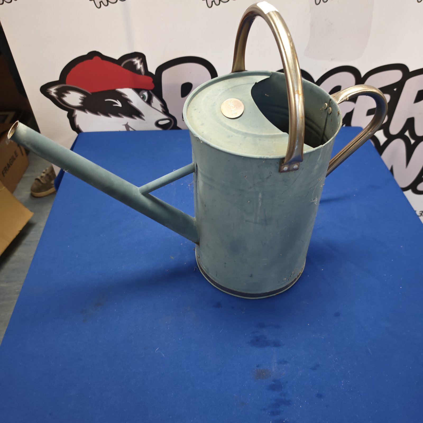 Vintage metal watering can with a weathered patina, ideal for garden use.