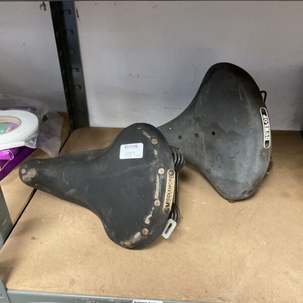 Pair of vintage black Middlemore and Dunlop bicycle saddles with metal plates