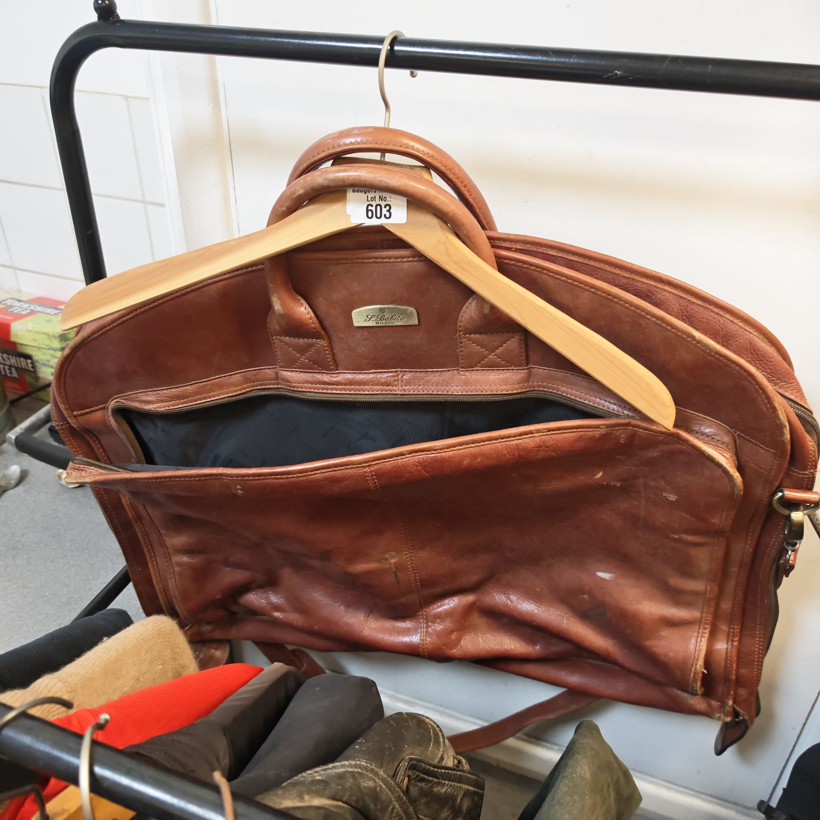 Vintage brown leather Milano suit bag for travel and garment protection.