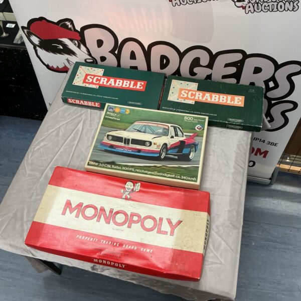 Vintage Monopoly and two Scrabble boxes with BMW 3.0 CSL puzzle on table