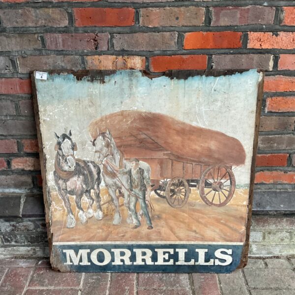 Vintage hand-painted Morrells pub sign showing horses pulling a hay cart
