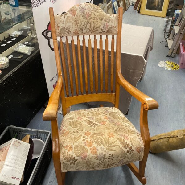 Vintage padded rocking chair with spindle back and floral upholstery