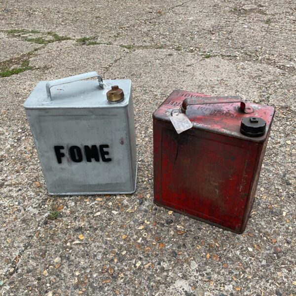 Vintage red and silver petrol cans, collectible fuel storage.