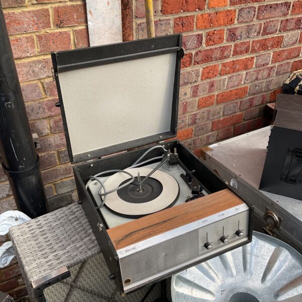Vintage Philips portable record player with open lid and wood-effect front panel