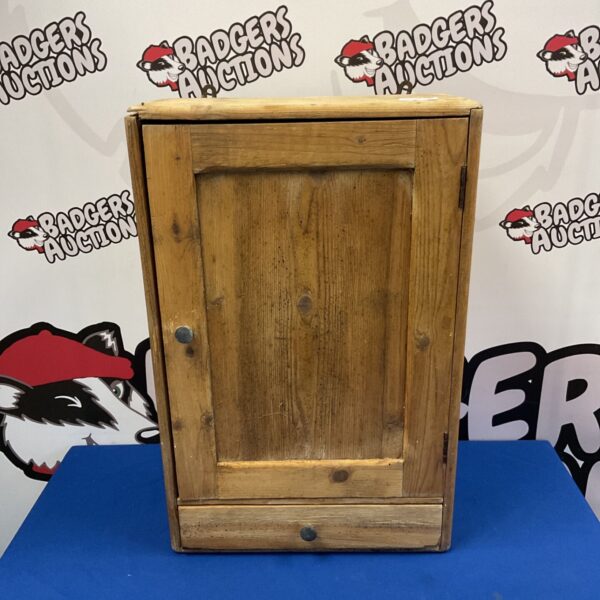 Vintage pine wall cabinet with drawer, front view.