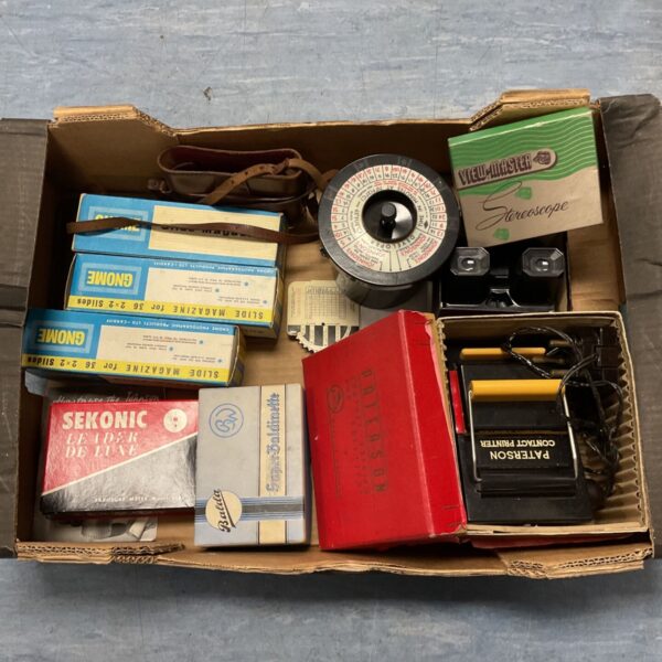 Tray of vintage projector and film accessories including View-Master stereoscope and slide magazines