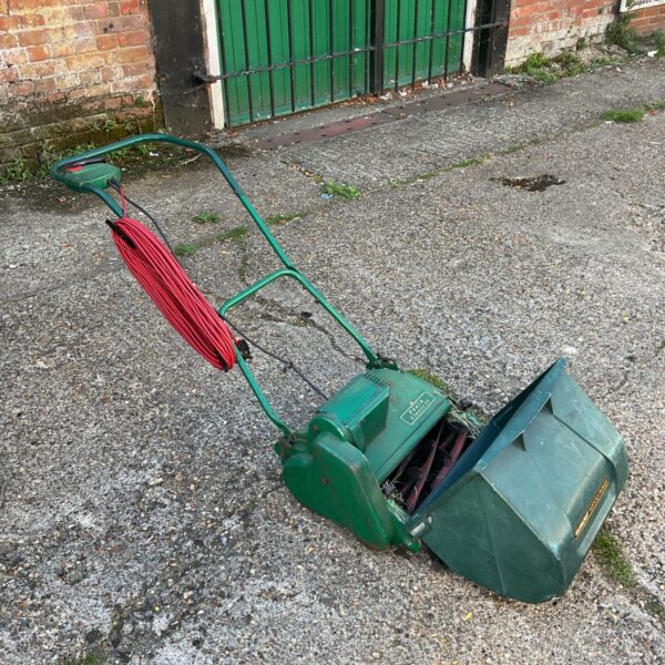 Vintage Punch classic 35 lawnmower in a garden setting.