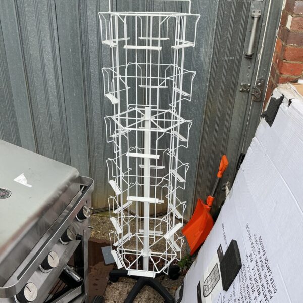 Vintage rotating shop card stand with chrome finish.